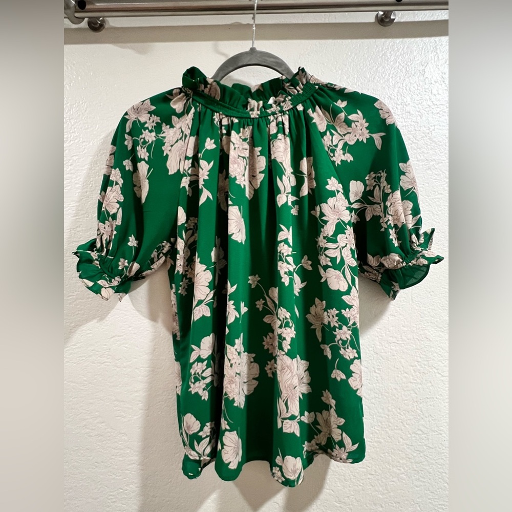 Three-quarter sleeves, green ruffle top with button in back